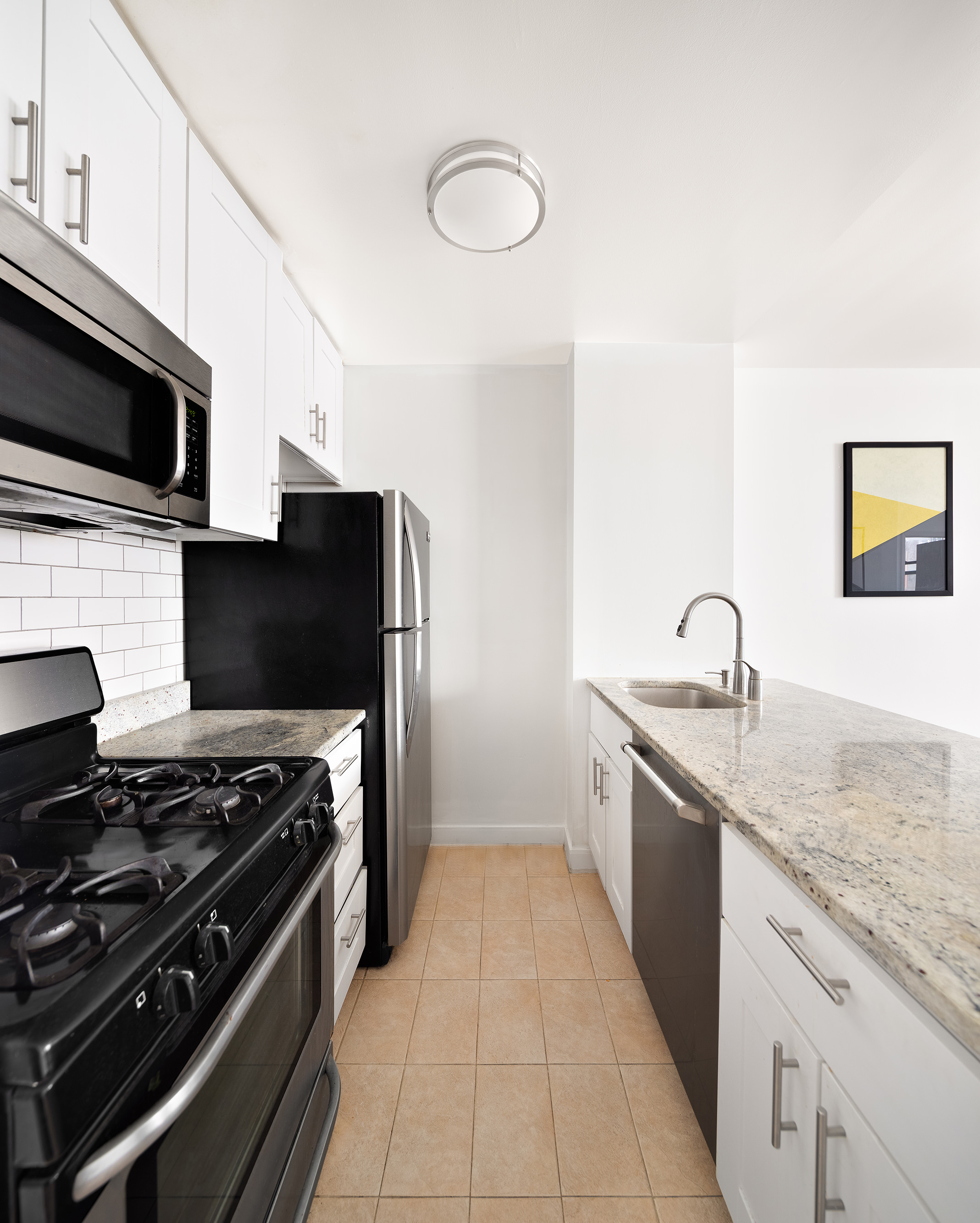 350 West 14th Street, Unit 7E Manhattan, NY 10014 - Photo 3 of 5 a kitchen with stainless steel appliances granite countertop a stove and a sink