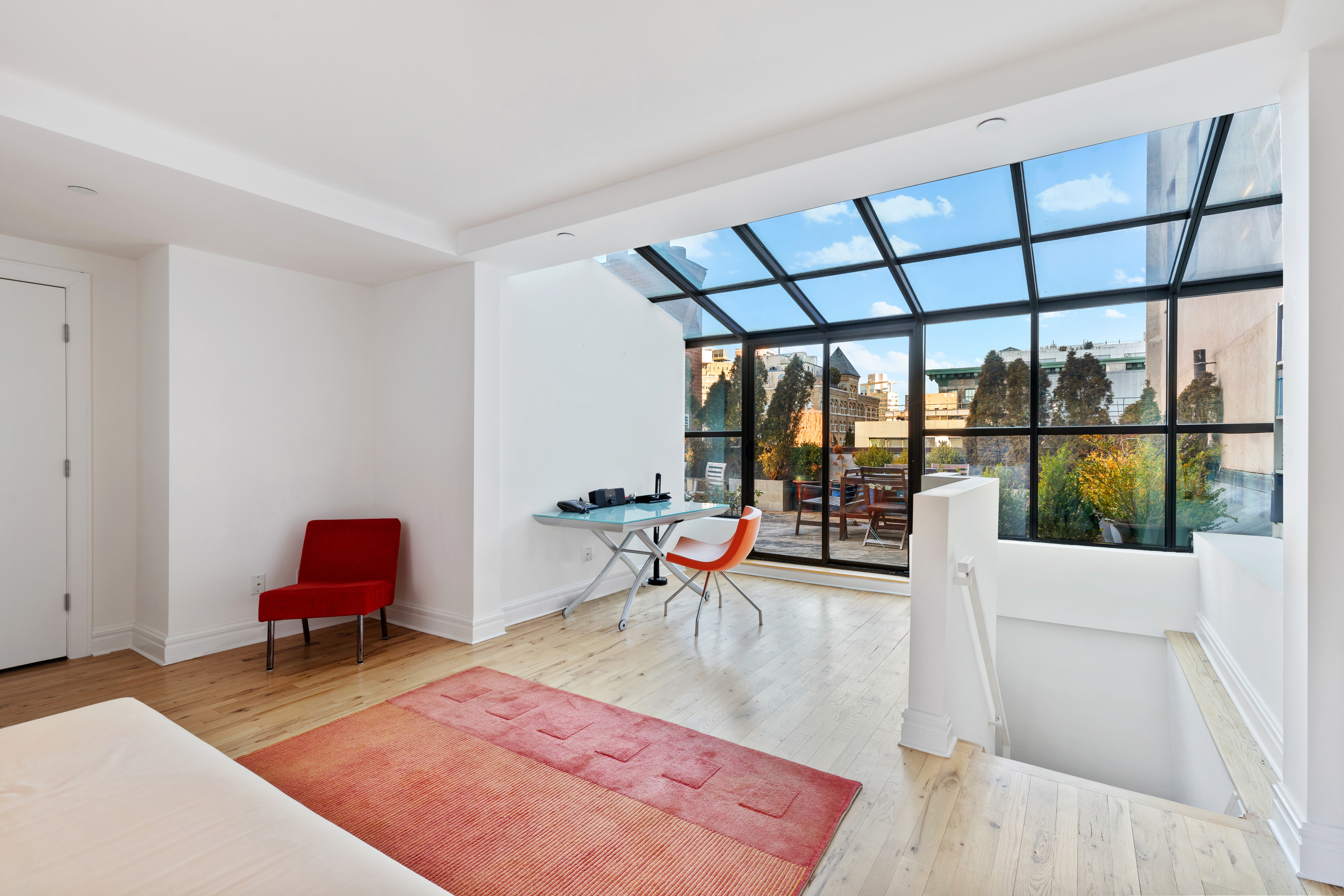 79 Laight Street, Unit 5H Manhattan, NY 10013 - Photo 12 of 13 a living room with furniture a rug and a table