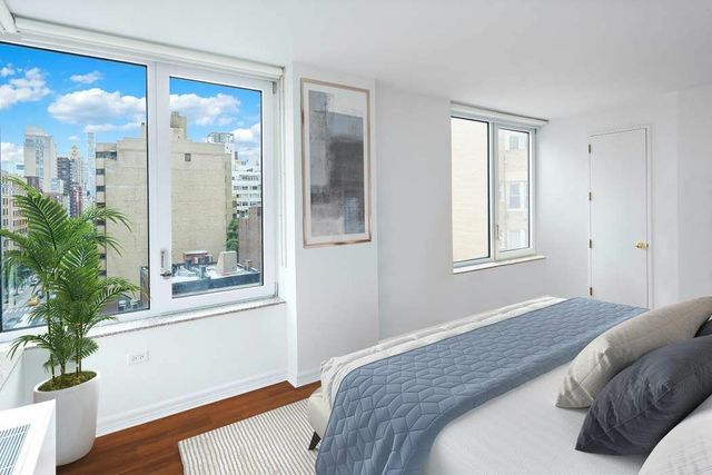 30 East 85th Street, Unit 8B Manhattan, NY 10028 - Photo 5 of 12 a bedroom with a bed and a window