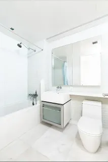 a bathroom with a sink a toilet and bathtub