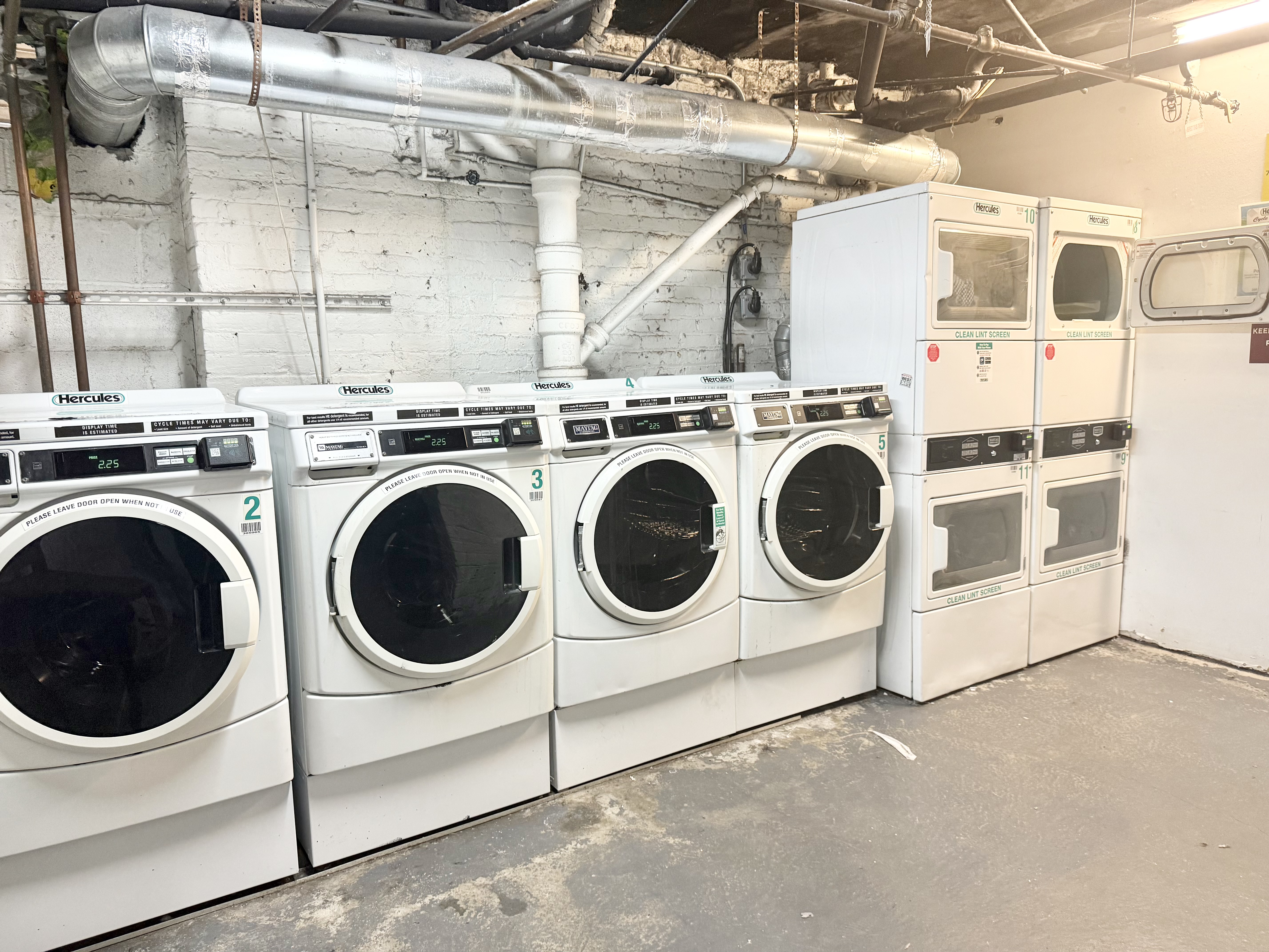 205 West 103rd Street, Unit 3A Manhattan, NY 10025 - Photo 6 of 9 a utility room with dryer and washer