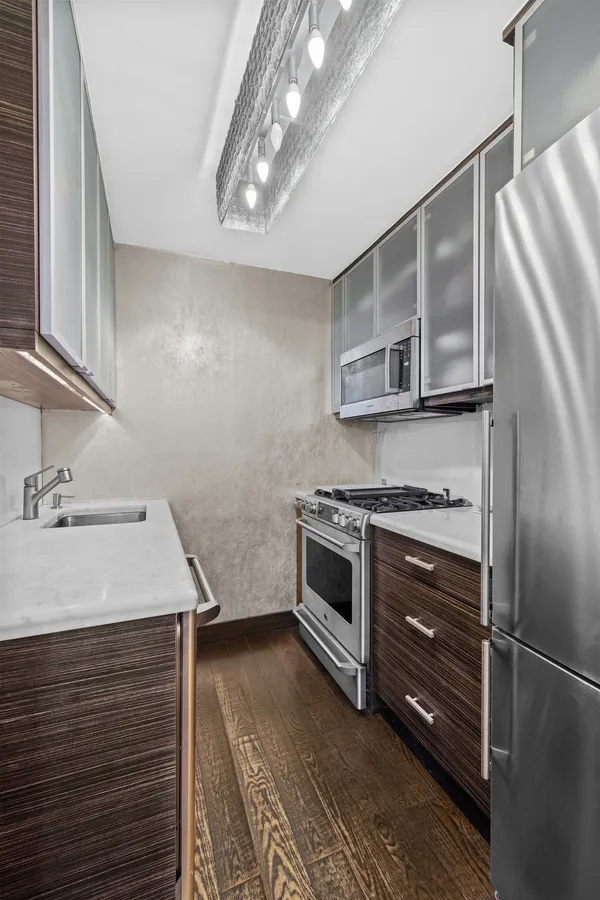 a kitchen with a refrigerator stove and sink
