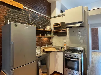 a kitchen with a stove and a refrigerator