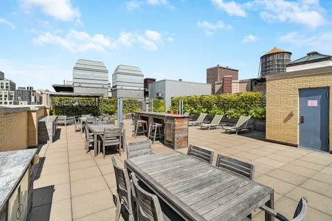 a view of a roof deck with furniture