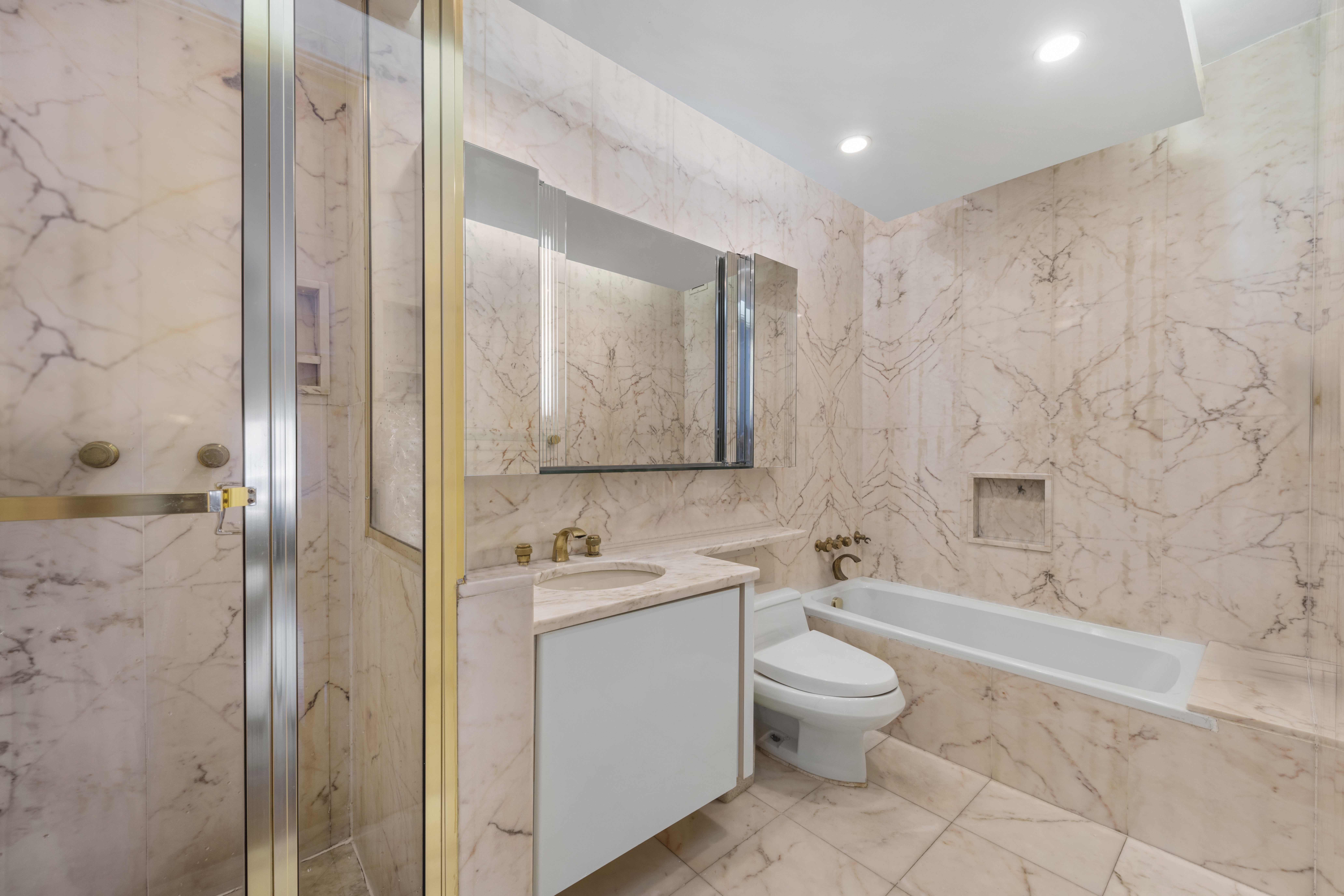530 East 76th Street Manhattan, NY 10021 - Photo 13 of 20 a bathroom with a toilet a sink and a bathtub
