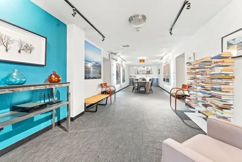a living room with furniture and a book shelf