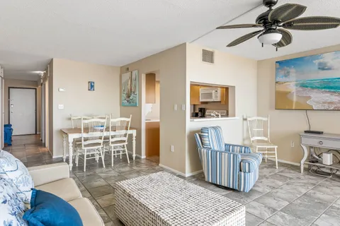 a dining room with furniture a rug and wooden floor