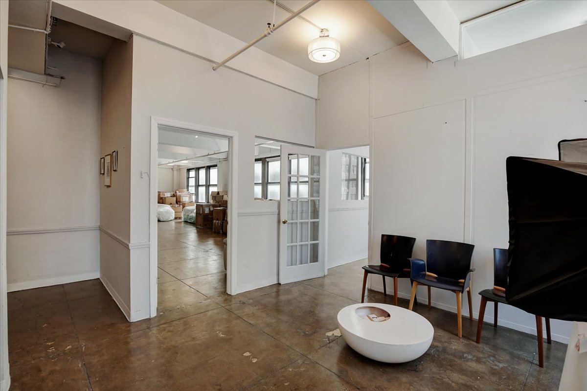 146 West 29th Street, Unit 9W Manhattan, NY 10001 - Photo 2 of 10 a living room with furniture and a flat screen tv