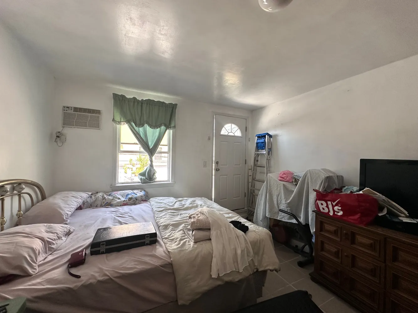 a bedroom with a bed and window