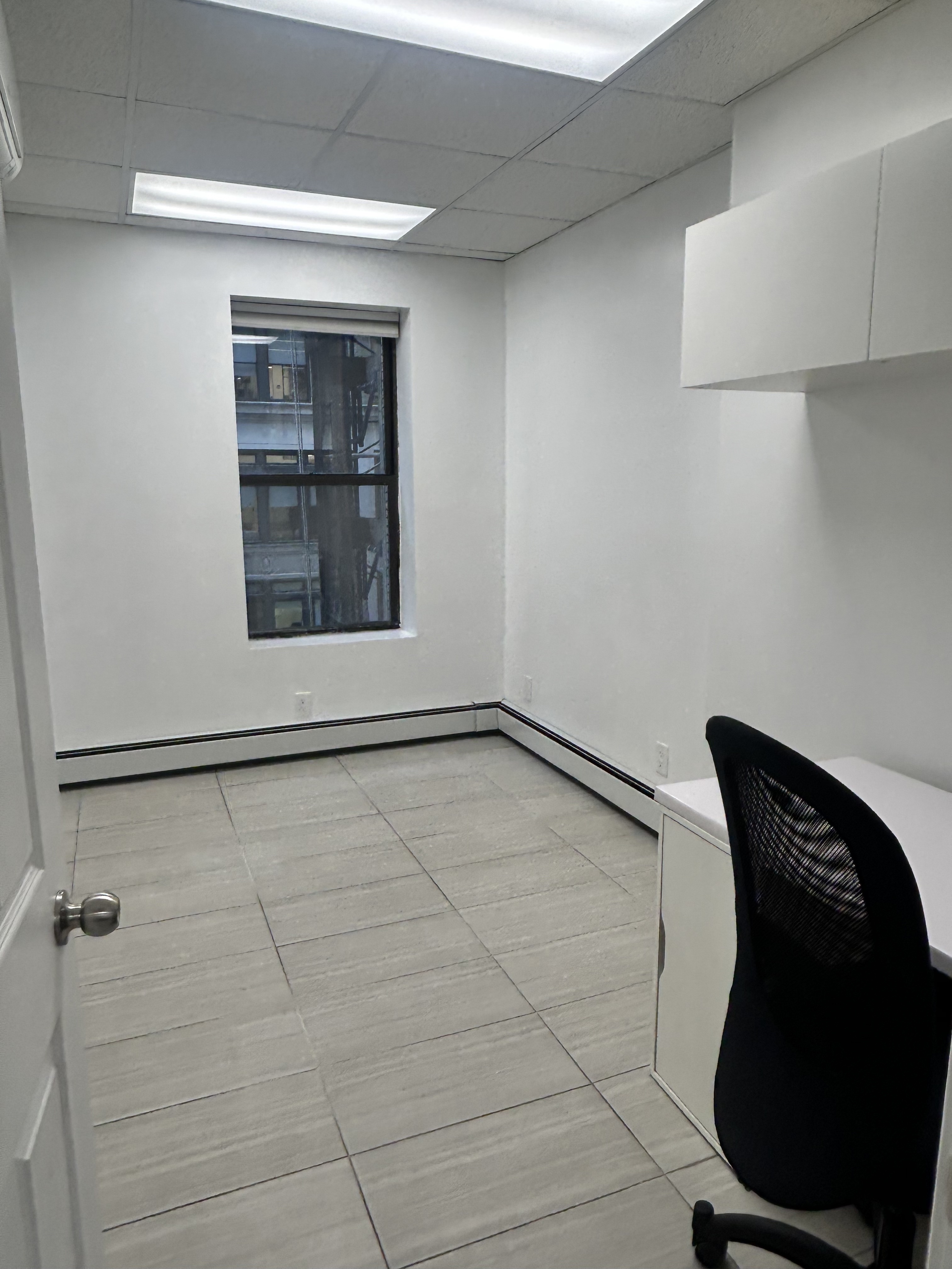 47 West 37th Street, Unit 4 Manhattan, NY 10018 - Photo 6 of 7 a view of a room with rack on the wall