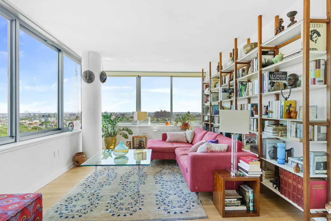 a living room with furniture and a floor to ceiling window