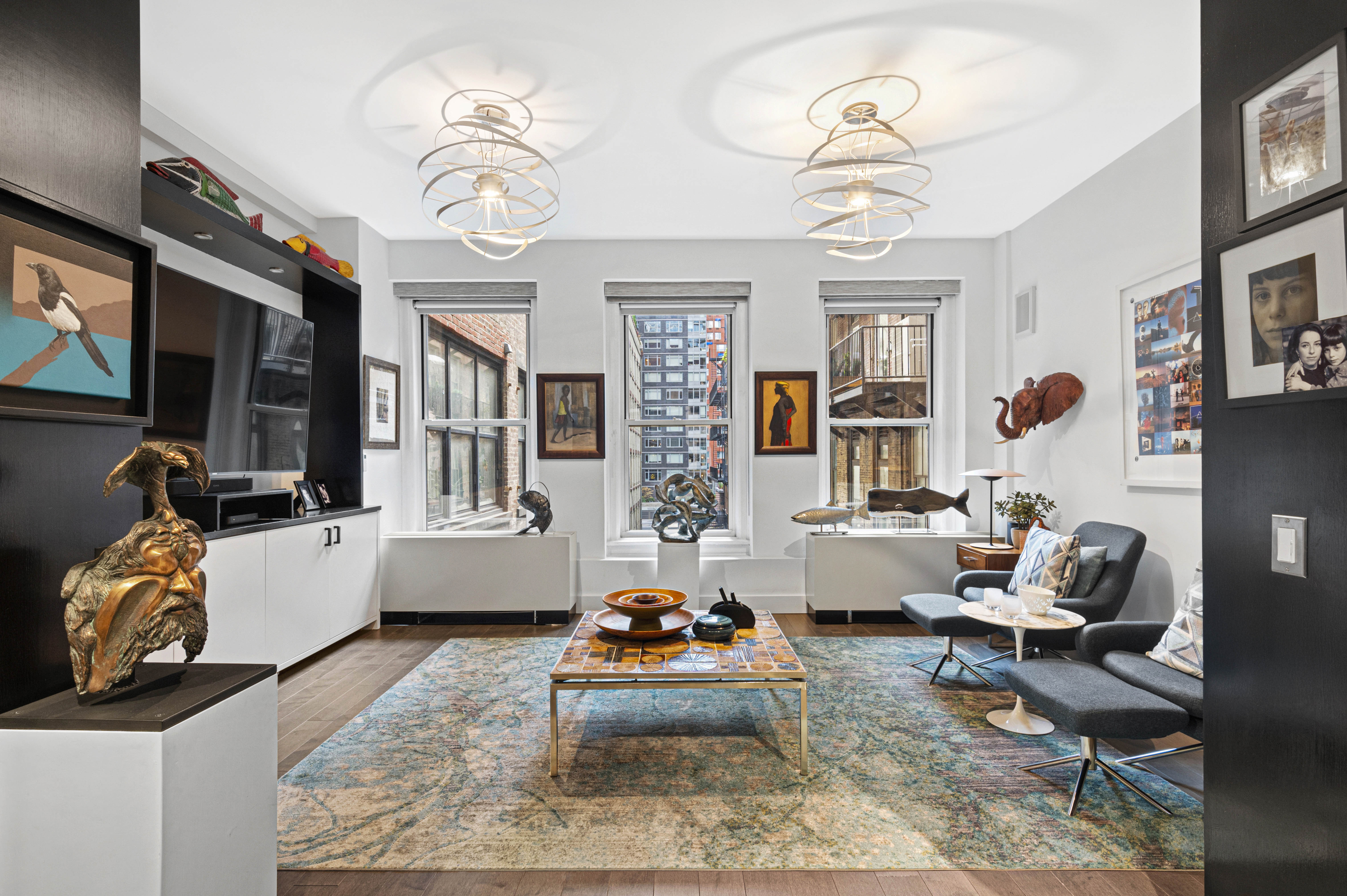 66 Leonard Street, Unit 4E Manhattan, NY 10013 - Photo 2 of 11 a living room with patio furniture and a chandelier