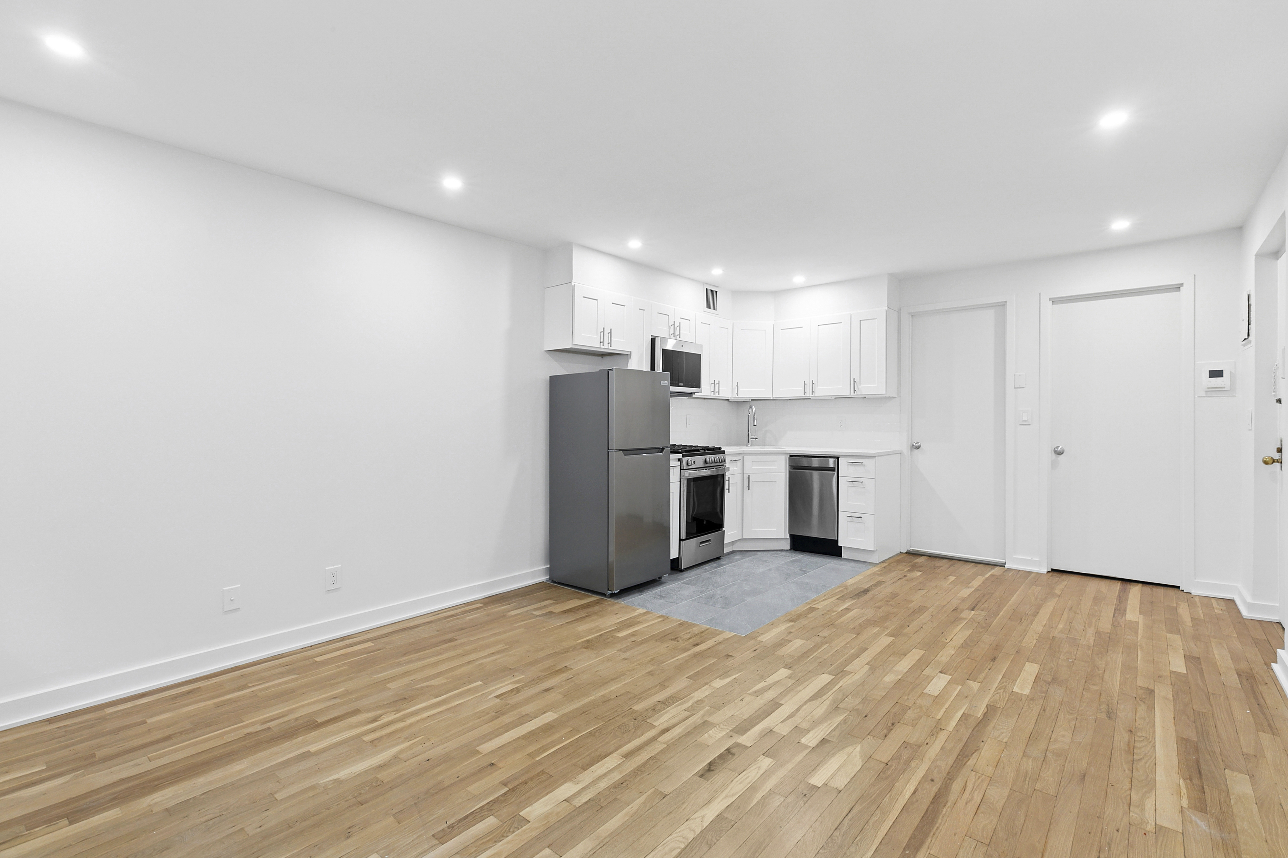 325 West 51st Street, Unit 1A Manhattan, NY 10019 - Photo 2 of 6 a view of a kitchen with a sink and a refrigerator