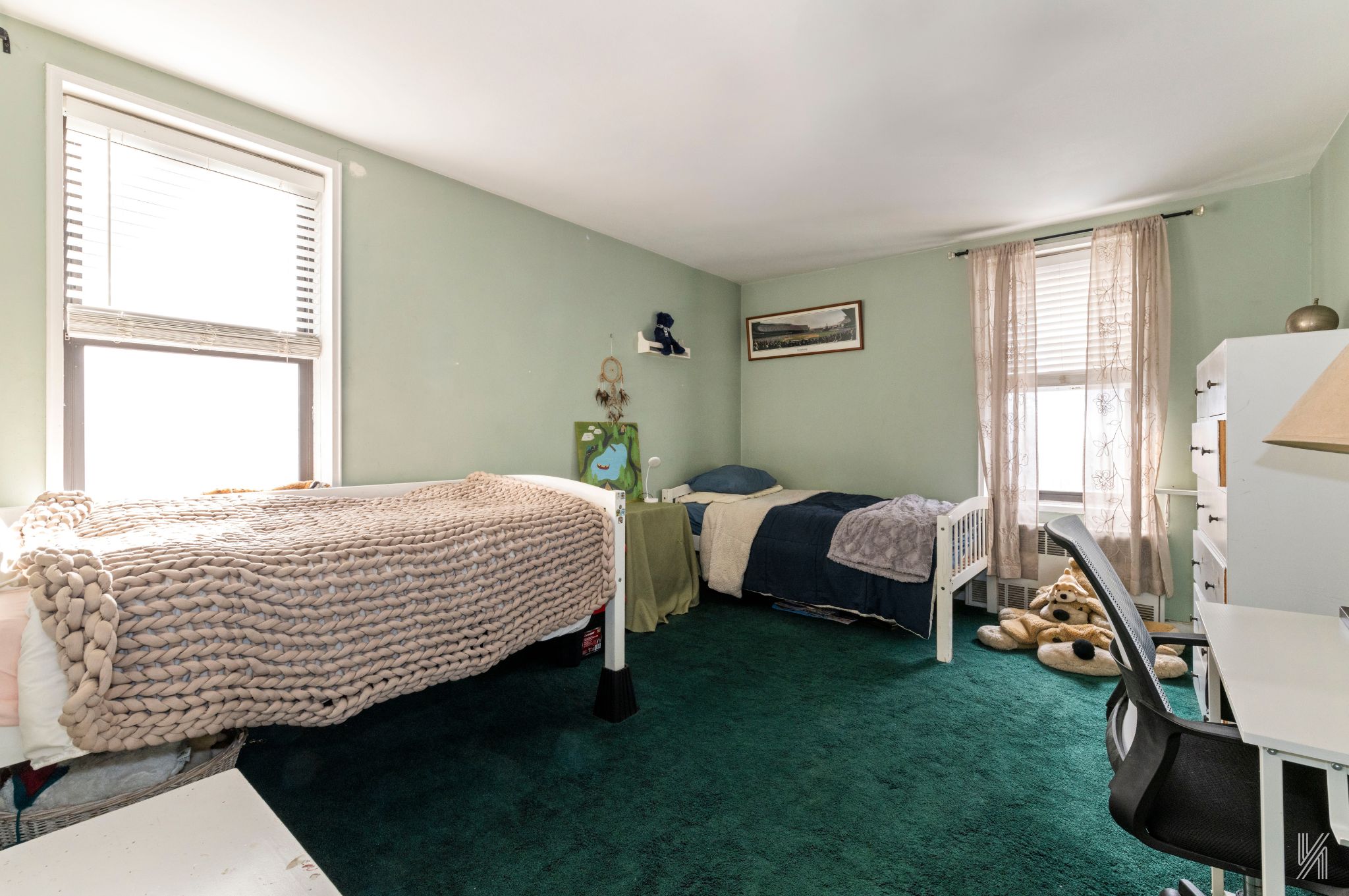 33-27 91st Street, Unit 3J Queens, NY 11372 - Photo 6 of 13 a bedroom with a bed and a window