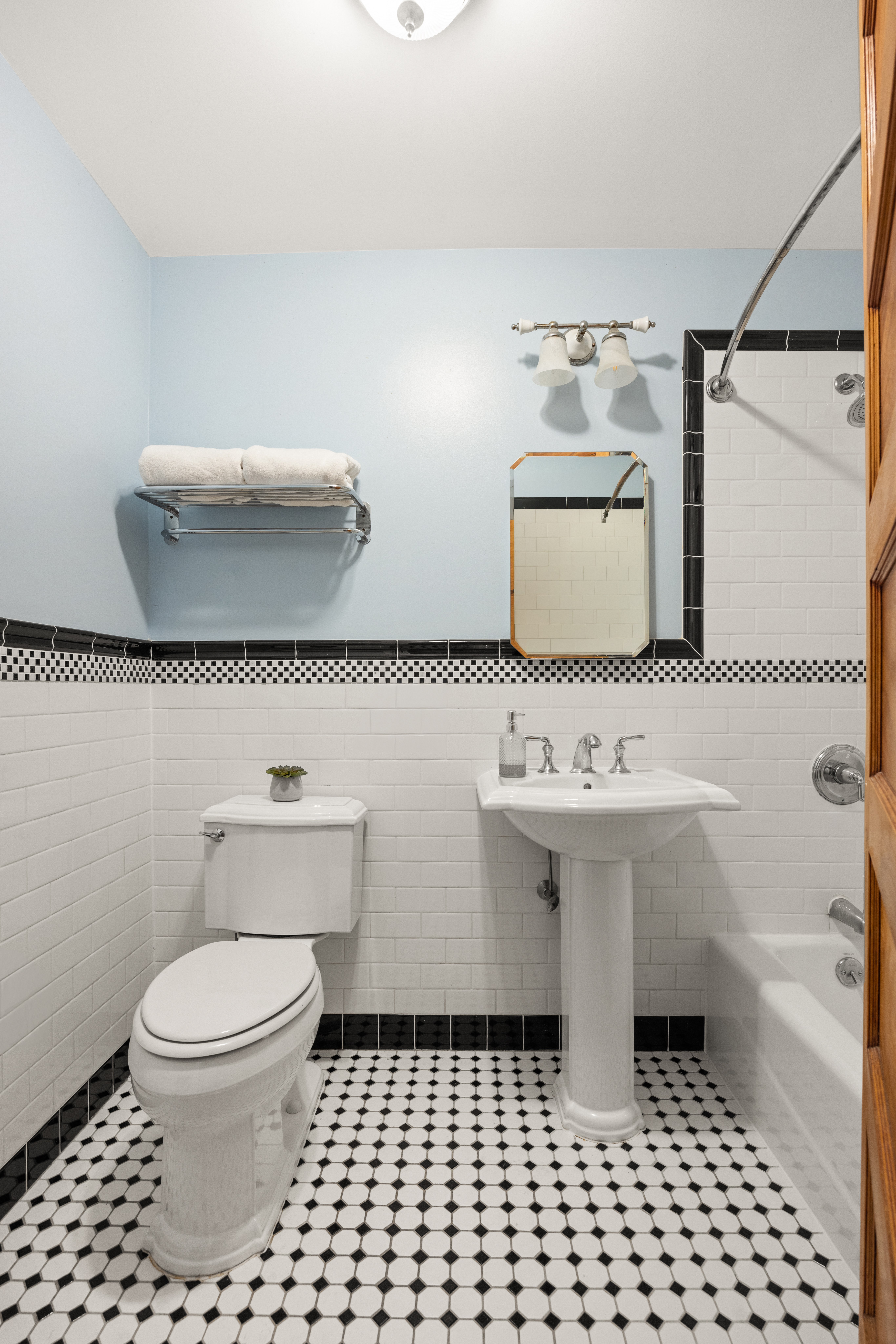 99 East 2nd Street Brooklyn, NY 11218 - Photo 21 of 24 a bathroom with a sink a toilet and mirror