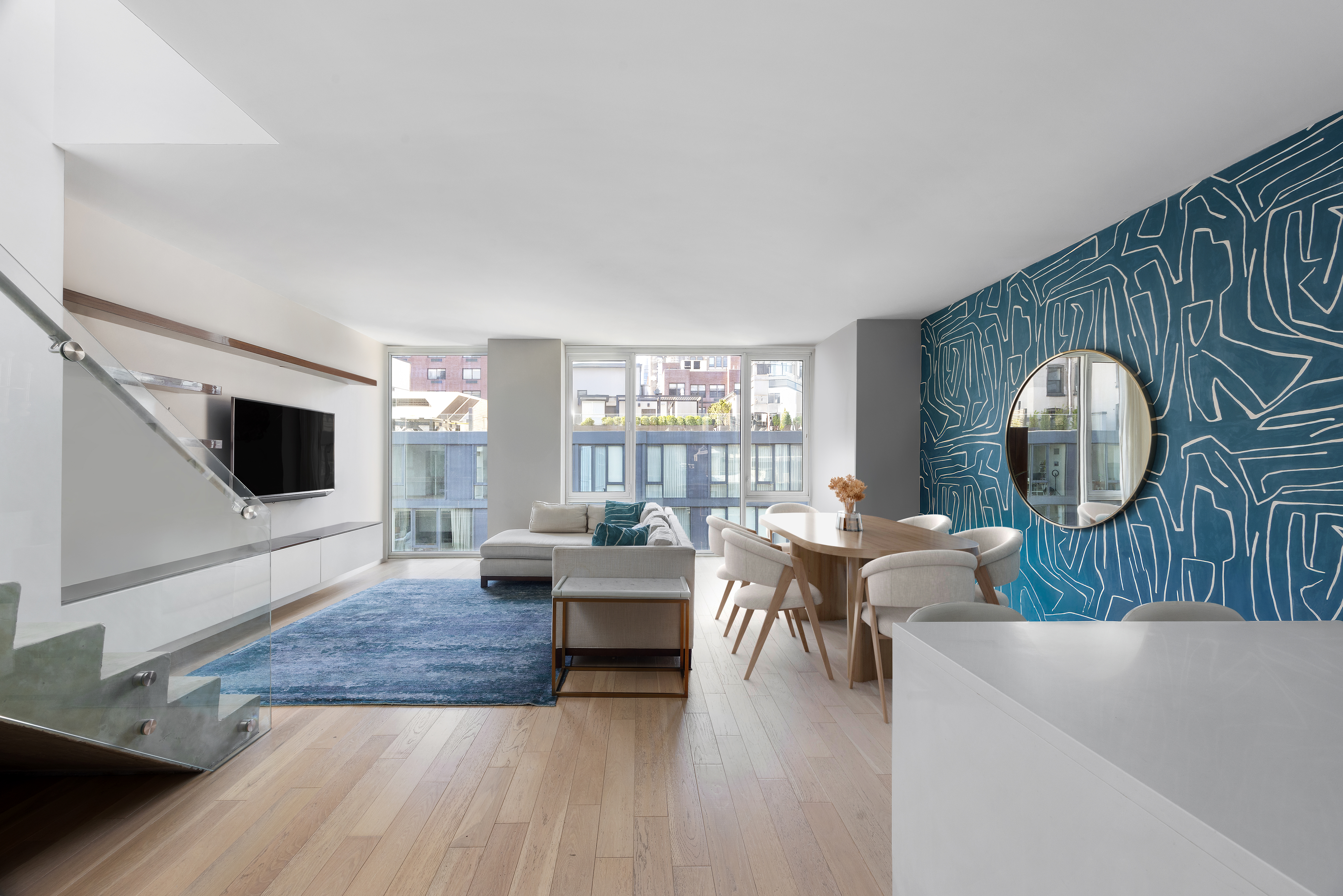 540 West 49th Street, Unit PH1N Manhattan, NY 10019 - Photo 1 of 18 a living room with furniture and a flat screen tv