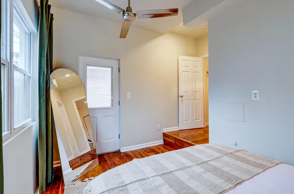 a bedroom with a bed and a mirror