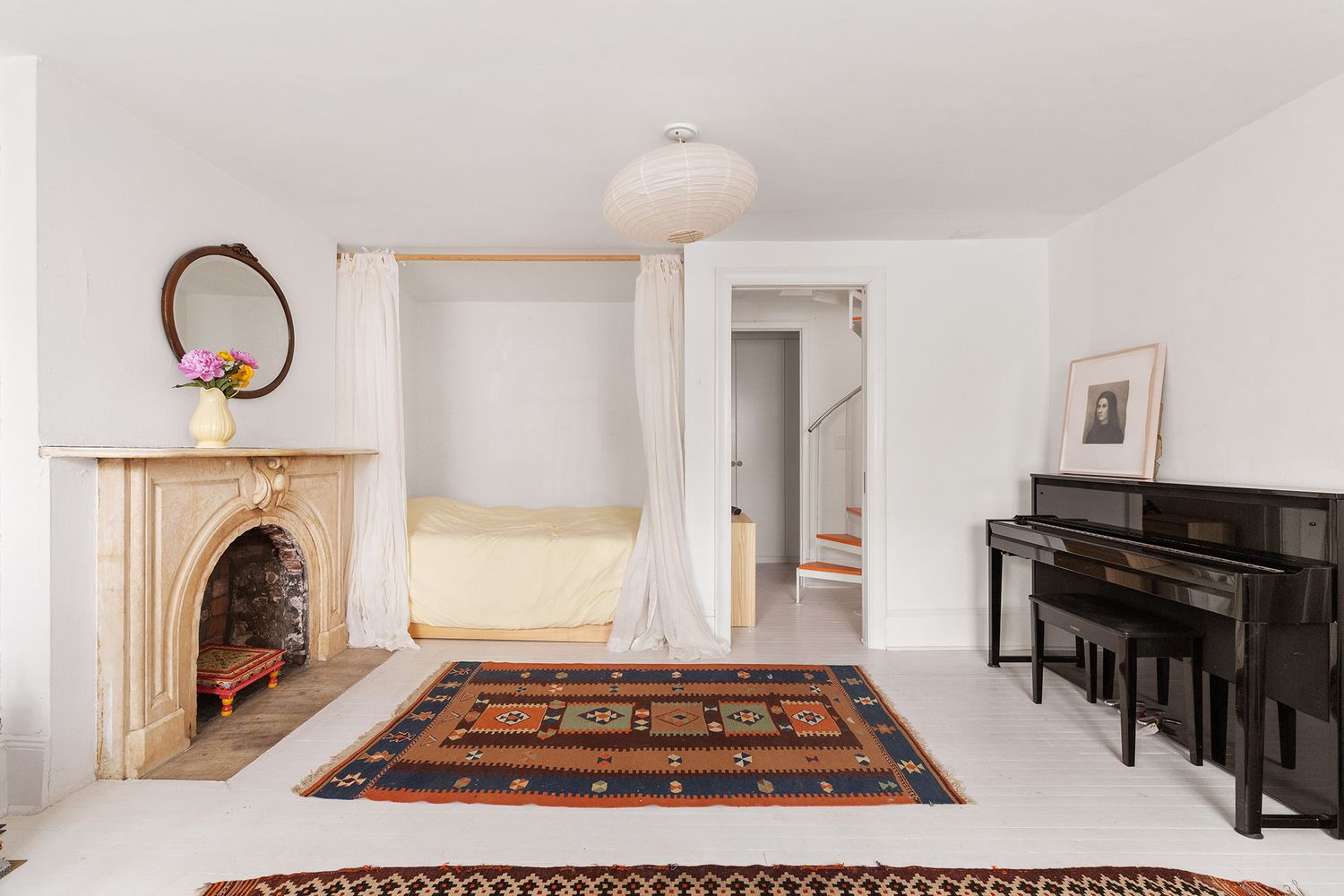 a living room with furniture a fireplace and a piano