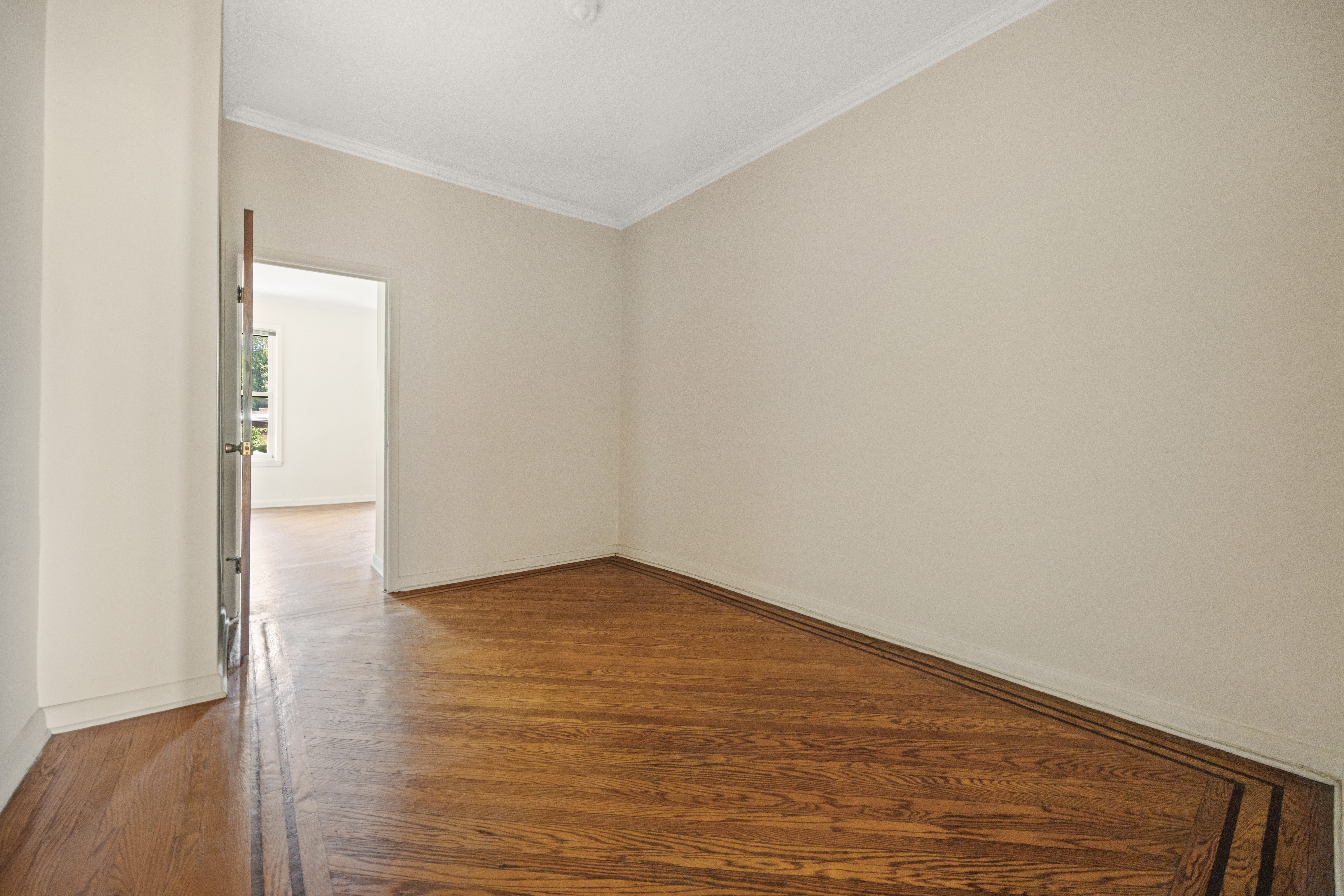 273 Windsor Place Brooklyn, NY 11218 - Photo 19 of 29 a view of an empty room with wooden floor