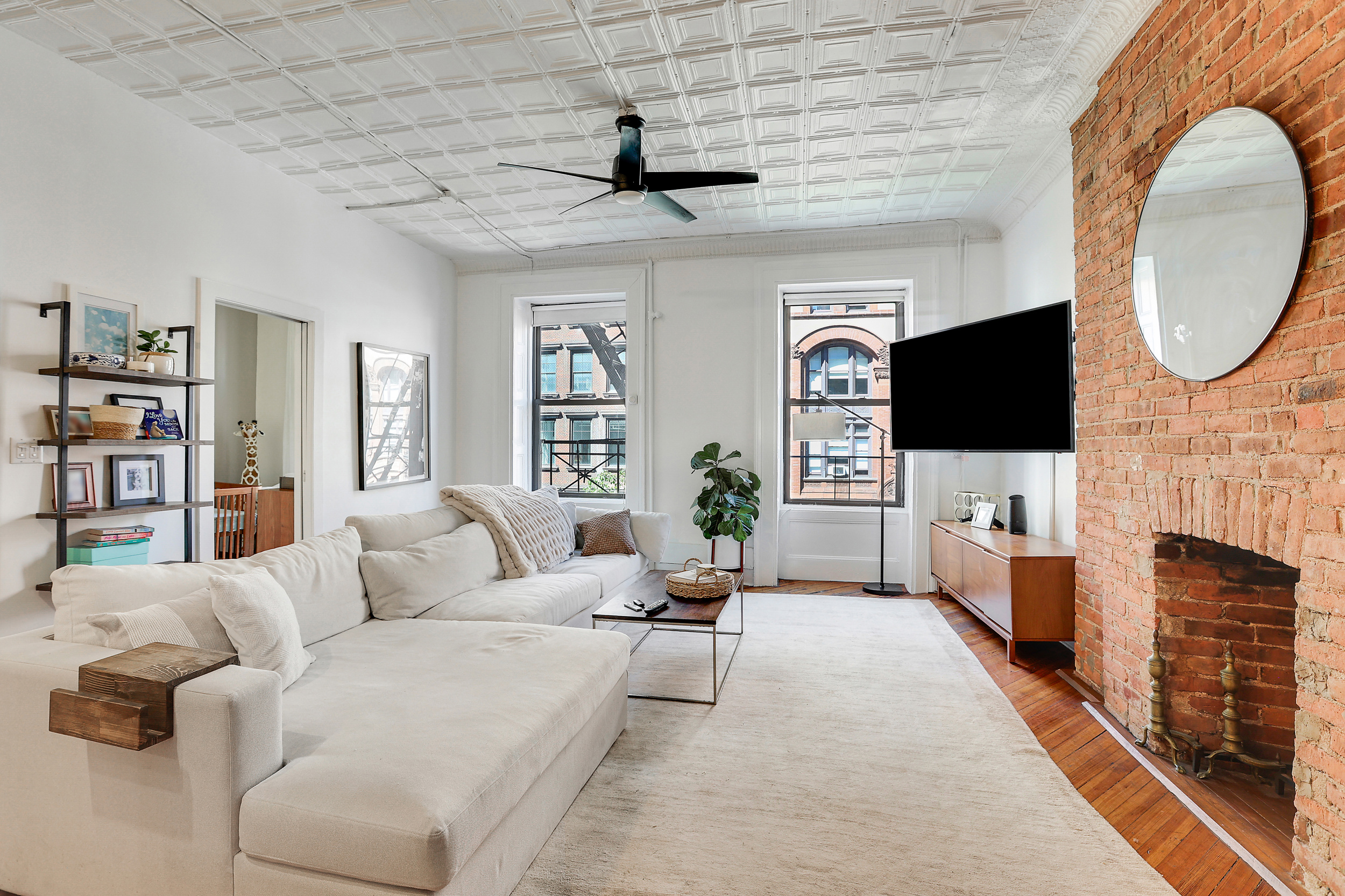 5 Great Jones Street Manhattan, NY 10012 - Photo 2 of 11 a living room with fireplace furniture and a flat screen tv