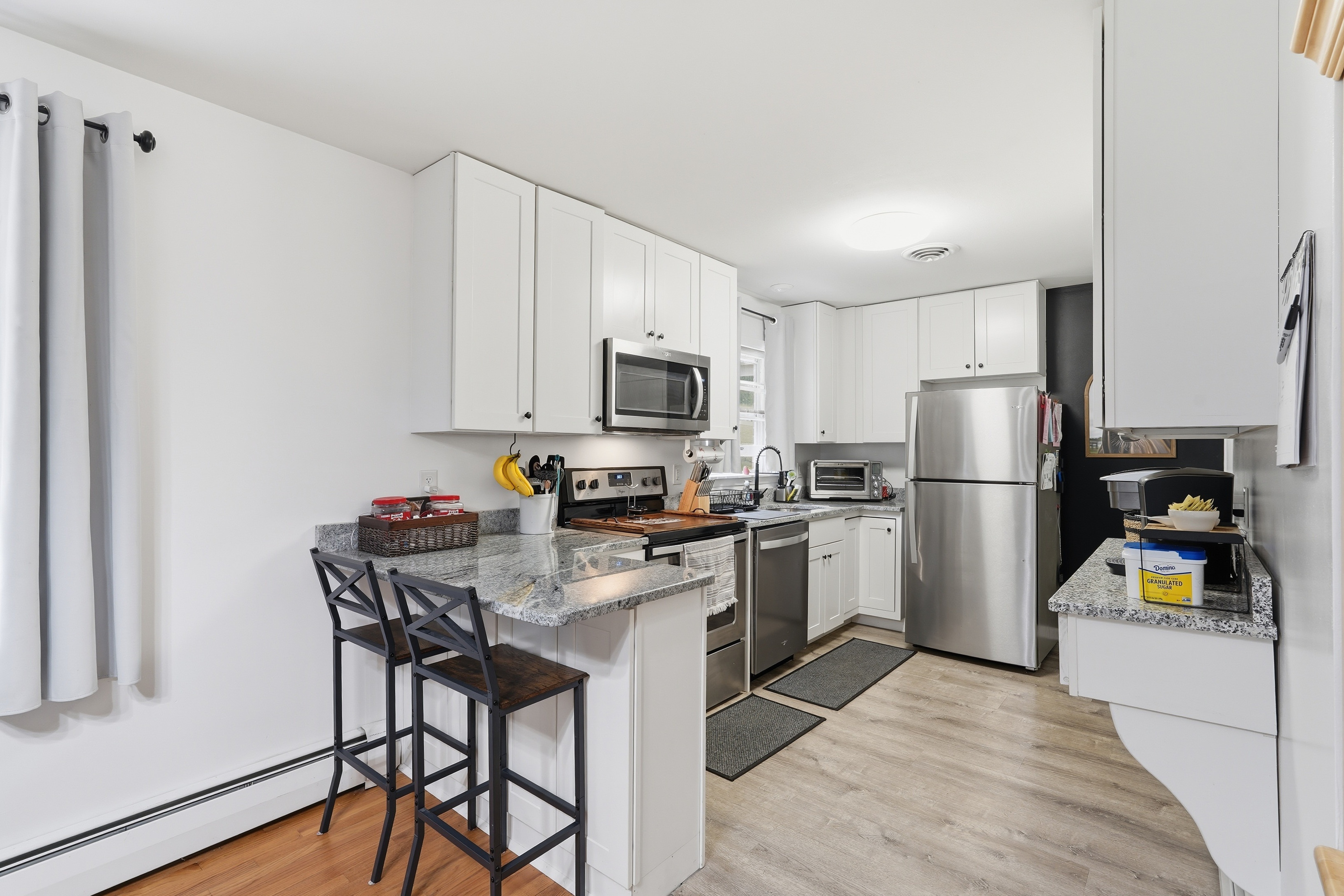 7717 McKaig Road Frederick, MD 21701 - Photo 14 of 53 a kitchen with a refrigerator a stove top oven and a center island