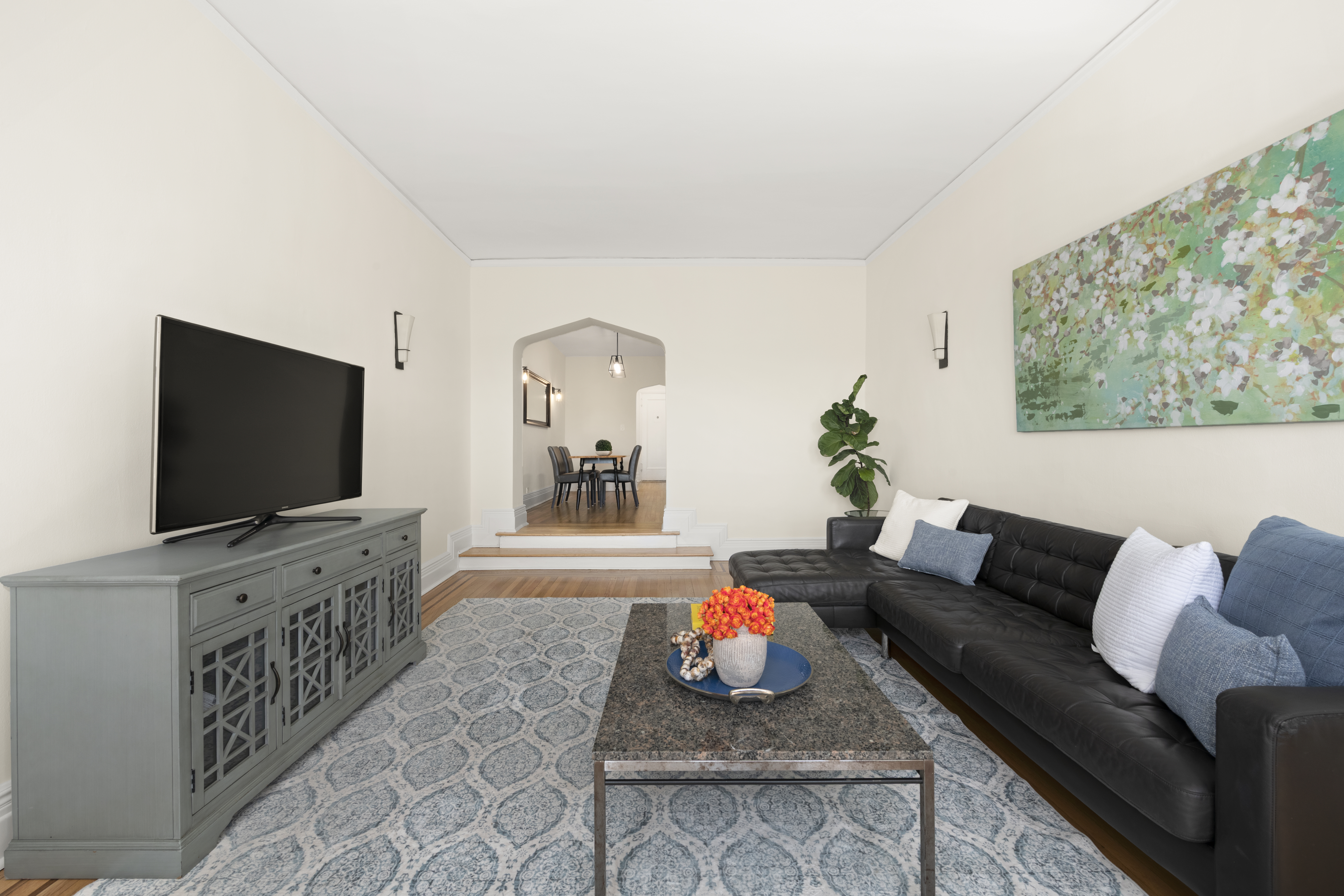 3875 Waldo Avenue, Unit 6E Bronx, NY 10463 - Photo 2 of 11 a living room with furniture and a flat screen tv