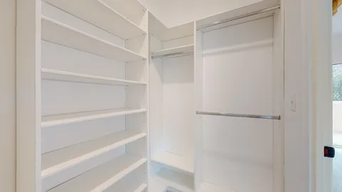 a bedroom with bed and glass door