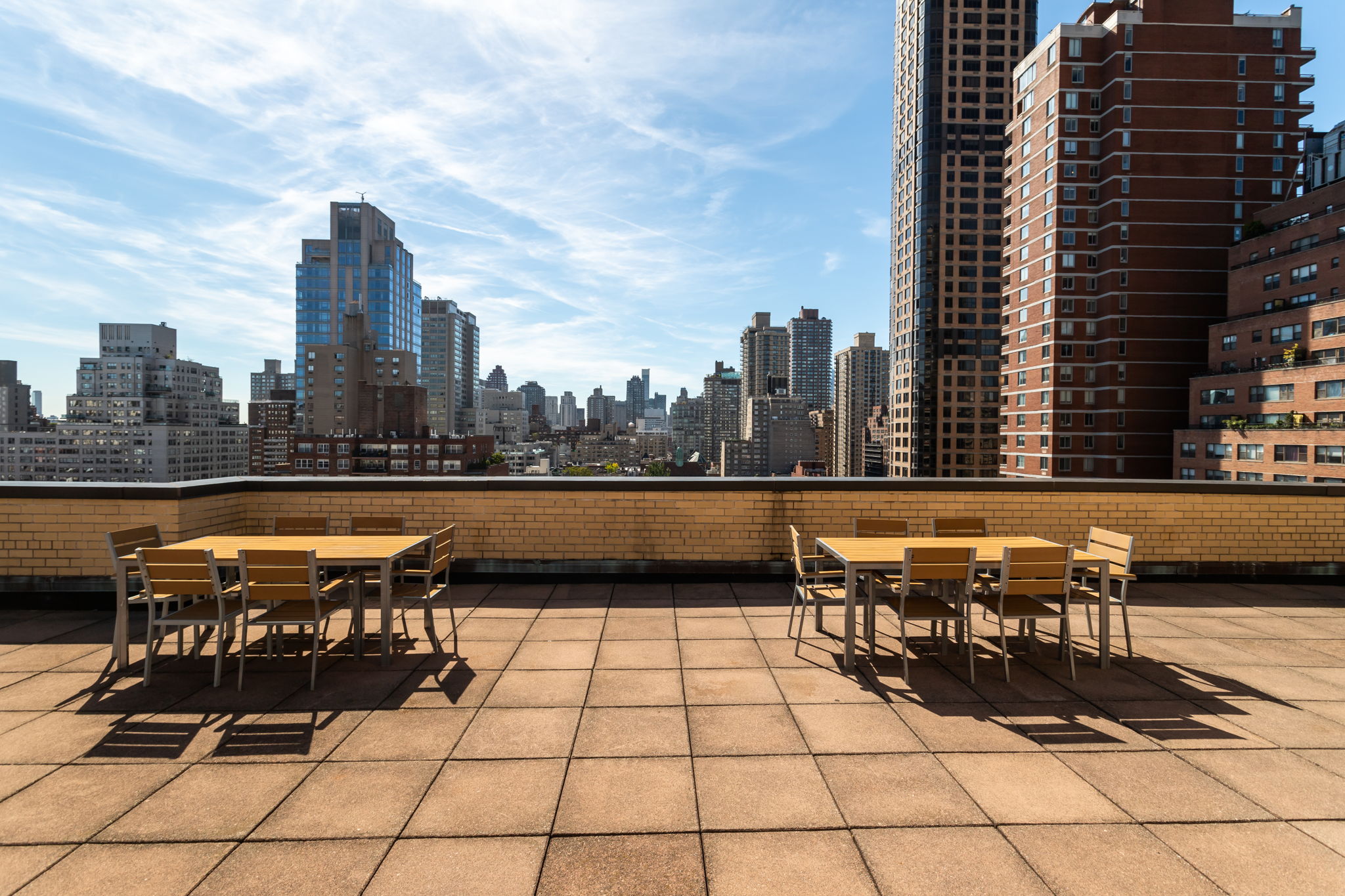415 East 85th Street, Unit 5J Manhattan, NY 10028 - Photo 17 of 19 a terrace with a bench and city view