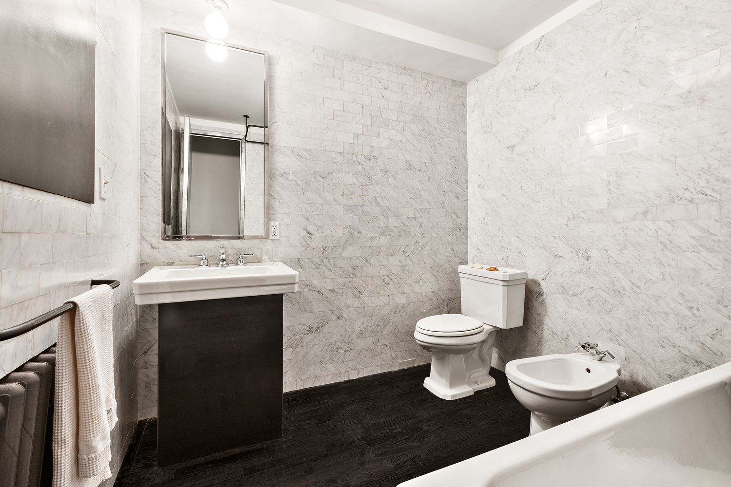 366 Broadway, Unit 5C Manhattan, NY 10013 - Photo 14 of 18 a bathroom with a toilet sink and mirror