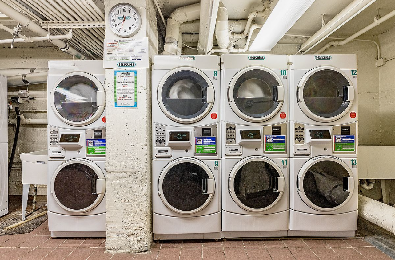 25 Minetta Lane, Unit 6G Manhattan, NY 10012 - Photo 13 of 13 a utility room with dryer and washer