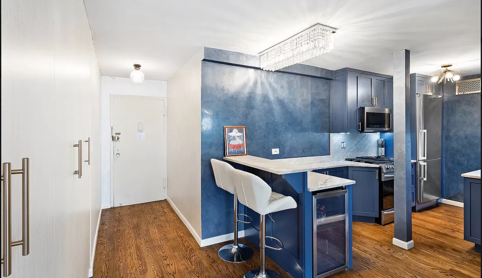 102-10 66th Road, Unit K25 Queens, NY 11375 - Photo 6 of 19 a kitchen with a wooden table and chairs