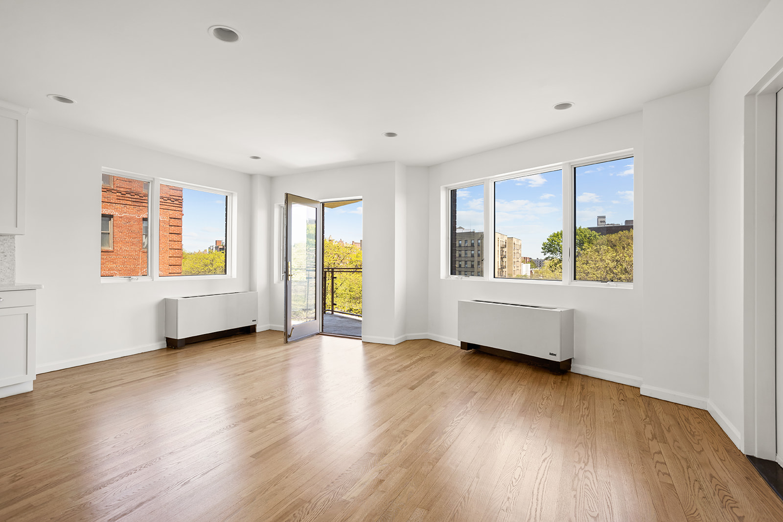 702 Ocean Parkway, Unit 5R Brooklyn, NY 11230 - Photo 2 of 13 a view of an empty room with a window and wooden floor