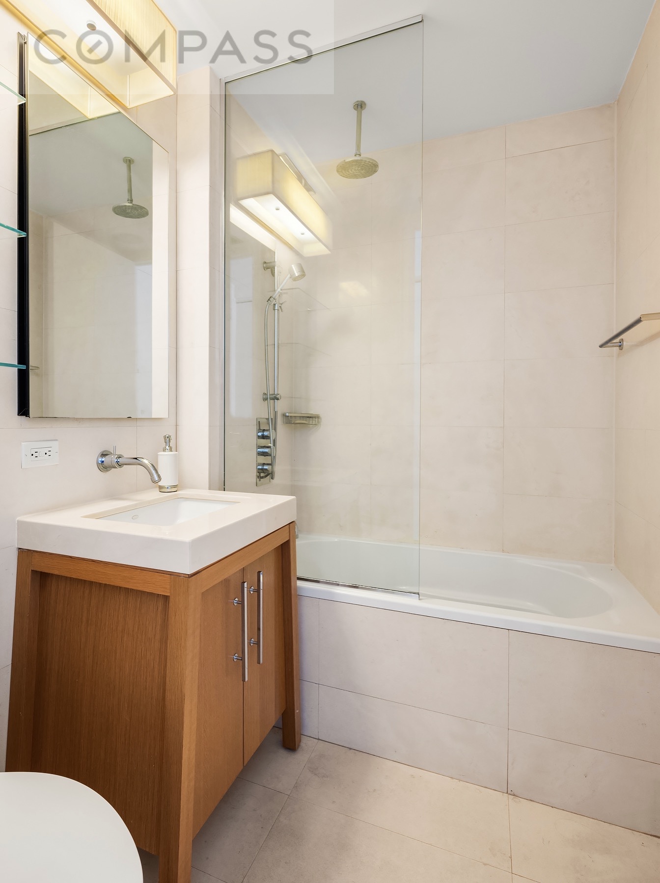 88 Greenwich Street, Unit 2903 Manhattan, NY 10006 - Photo 5 of 13 a bathroom with a sink a toilet and shower