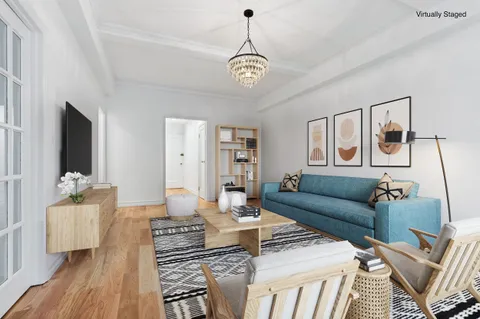 a living room with furniture a couch and a chandelier