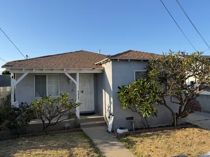 a house that has a tree in front of it