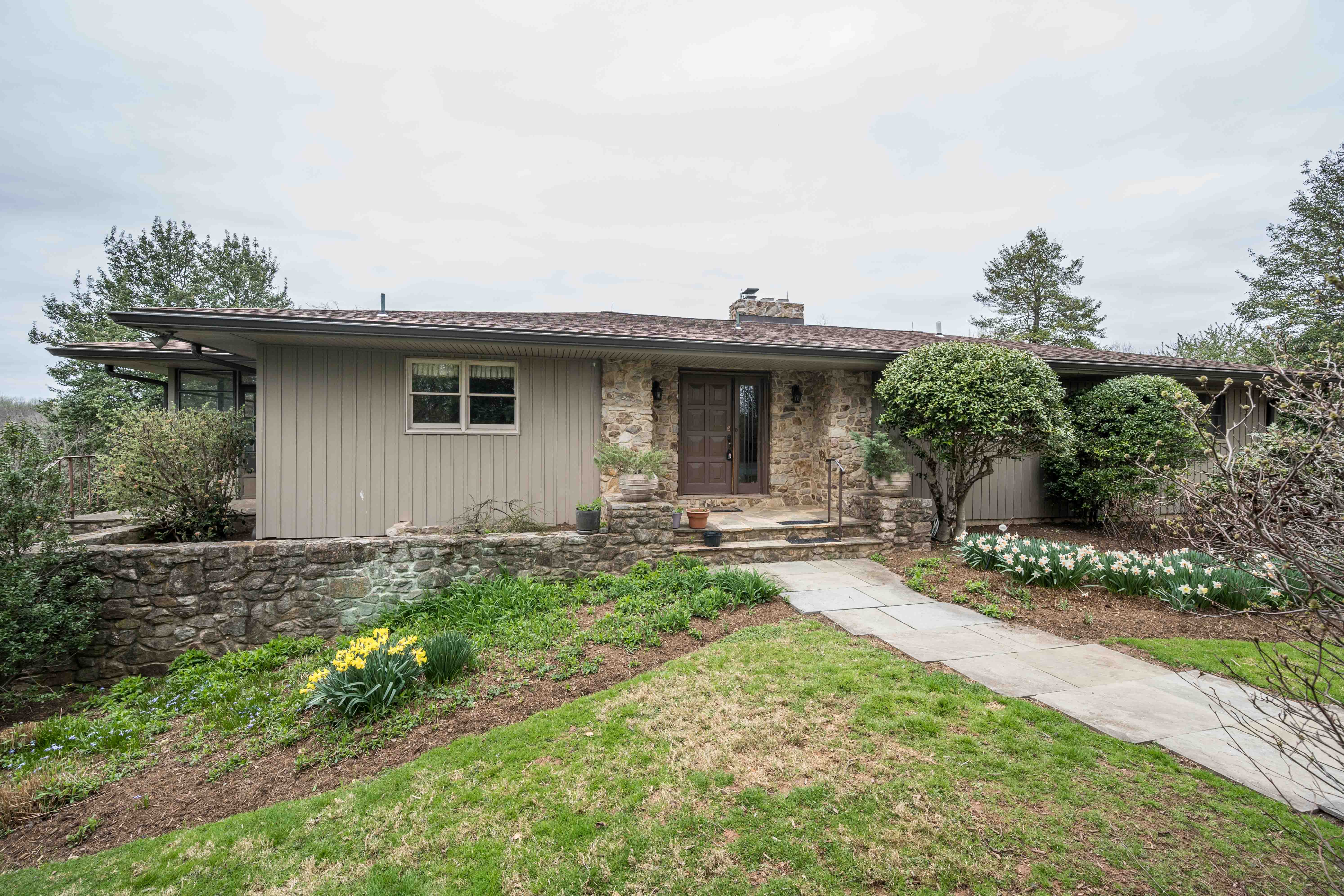 a front view of a house with garden