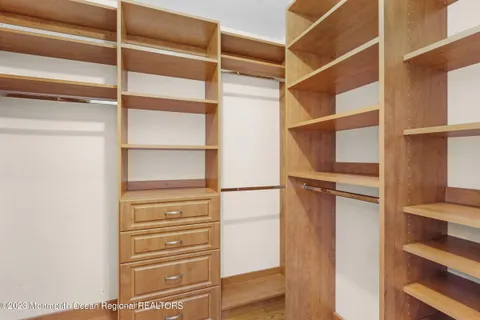 a view of walk in closet with empty racks