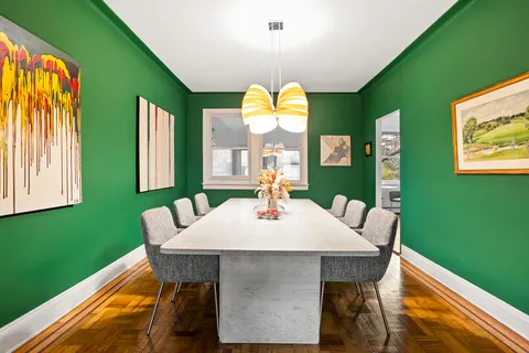 a view of a dining room with furniture and a window