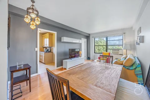 a dining room with furniture and a window