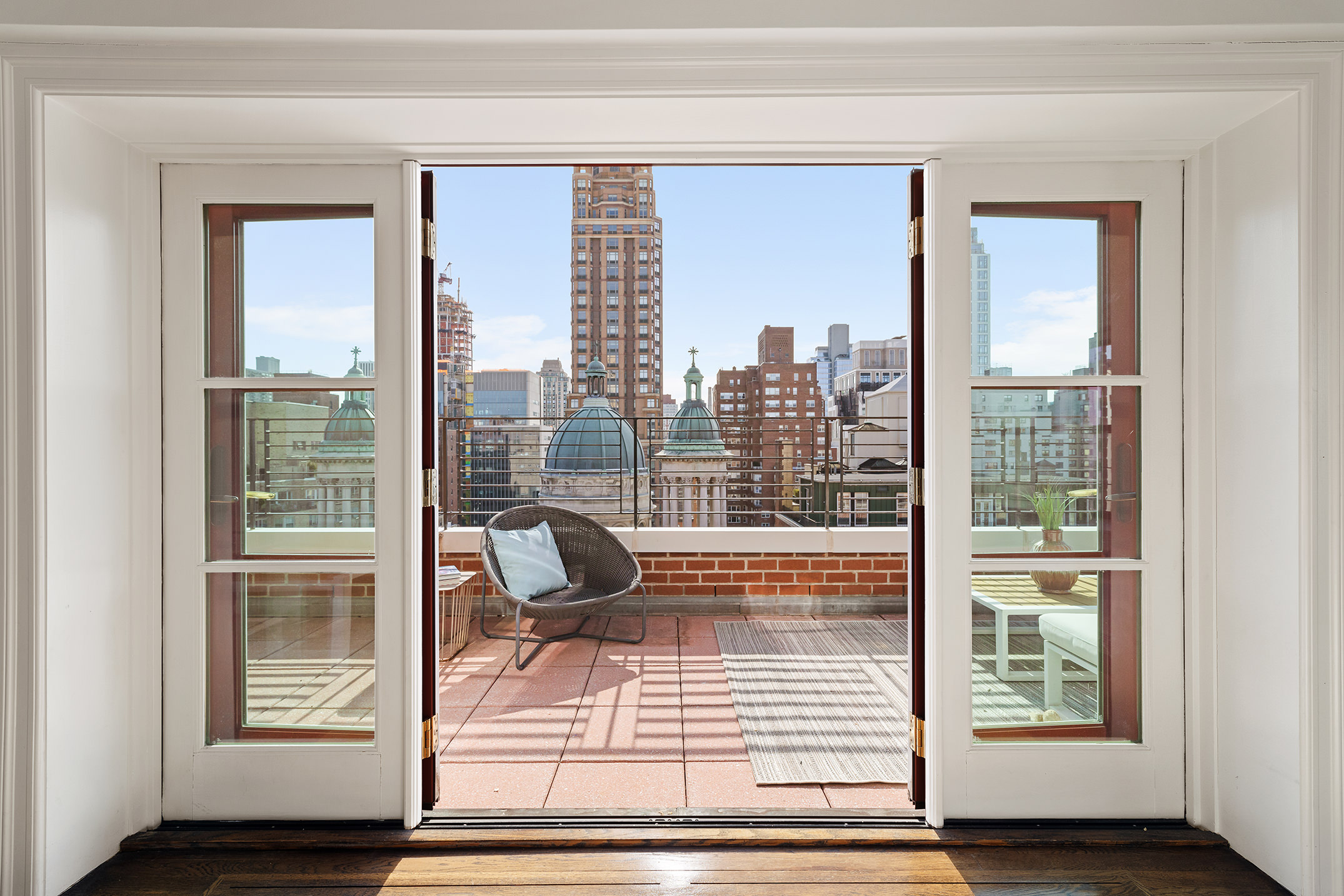 136 East 76th Street, Unit 16DE Manhattan, NY 10021 - Photo 2 of 14 a living room with a floor to ceiling window and wooden floor