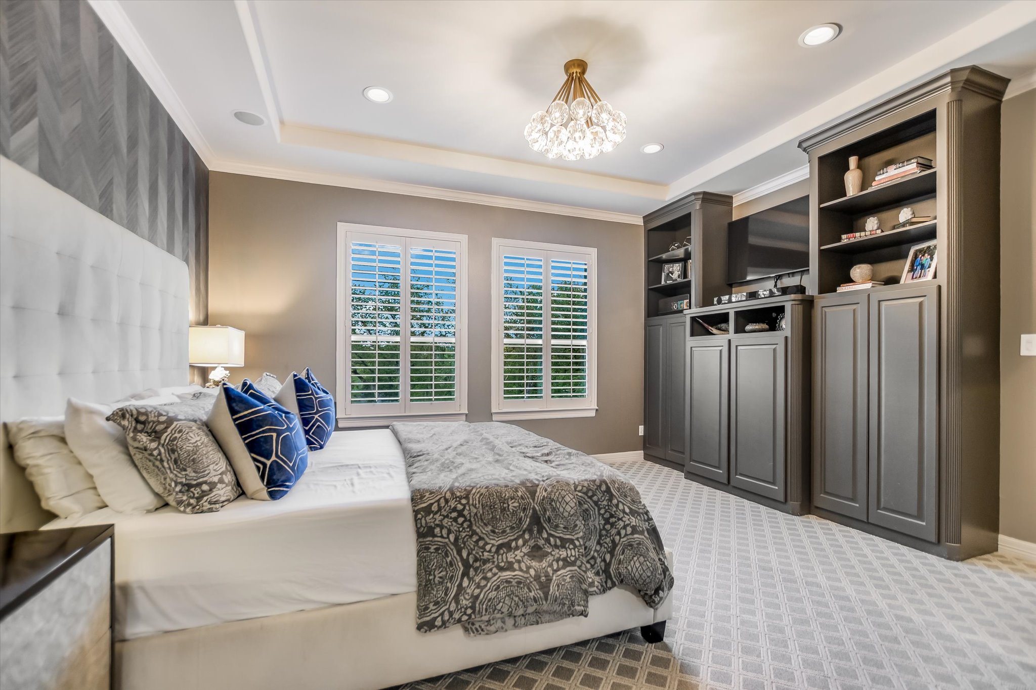 1422 Palomino Ridge Drive Austin, TX 78733 - Photo 20 of 60 a bedroom with a bed and a chandelier