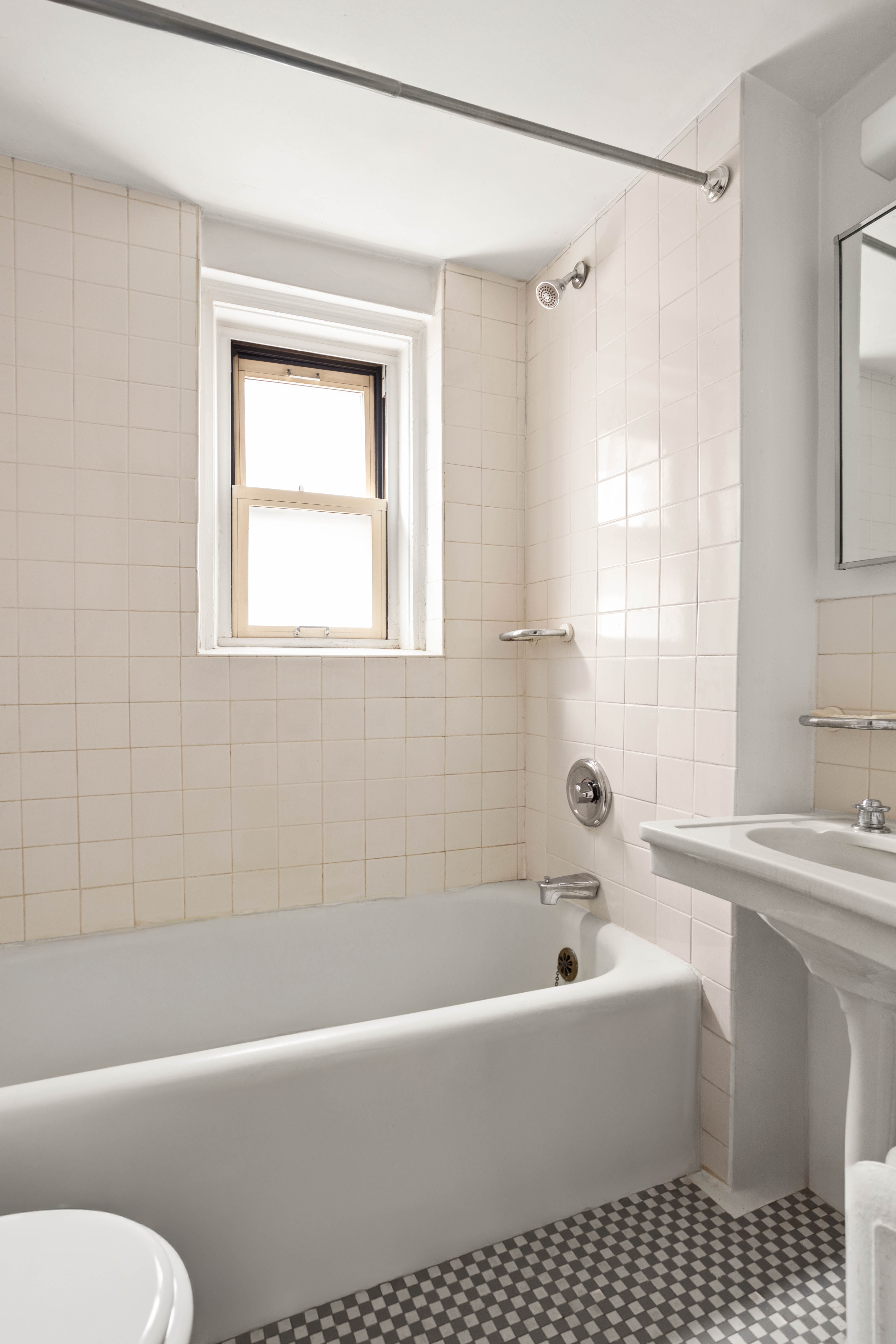 155 East 49th Street, Unit 10C Manhattan, NY 10017 - Photo 4 of 7 a bathroom with a bathtub a toilet and a shower