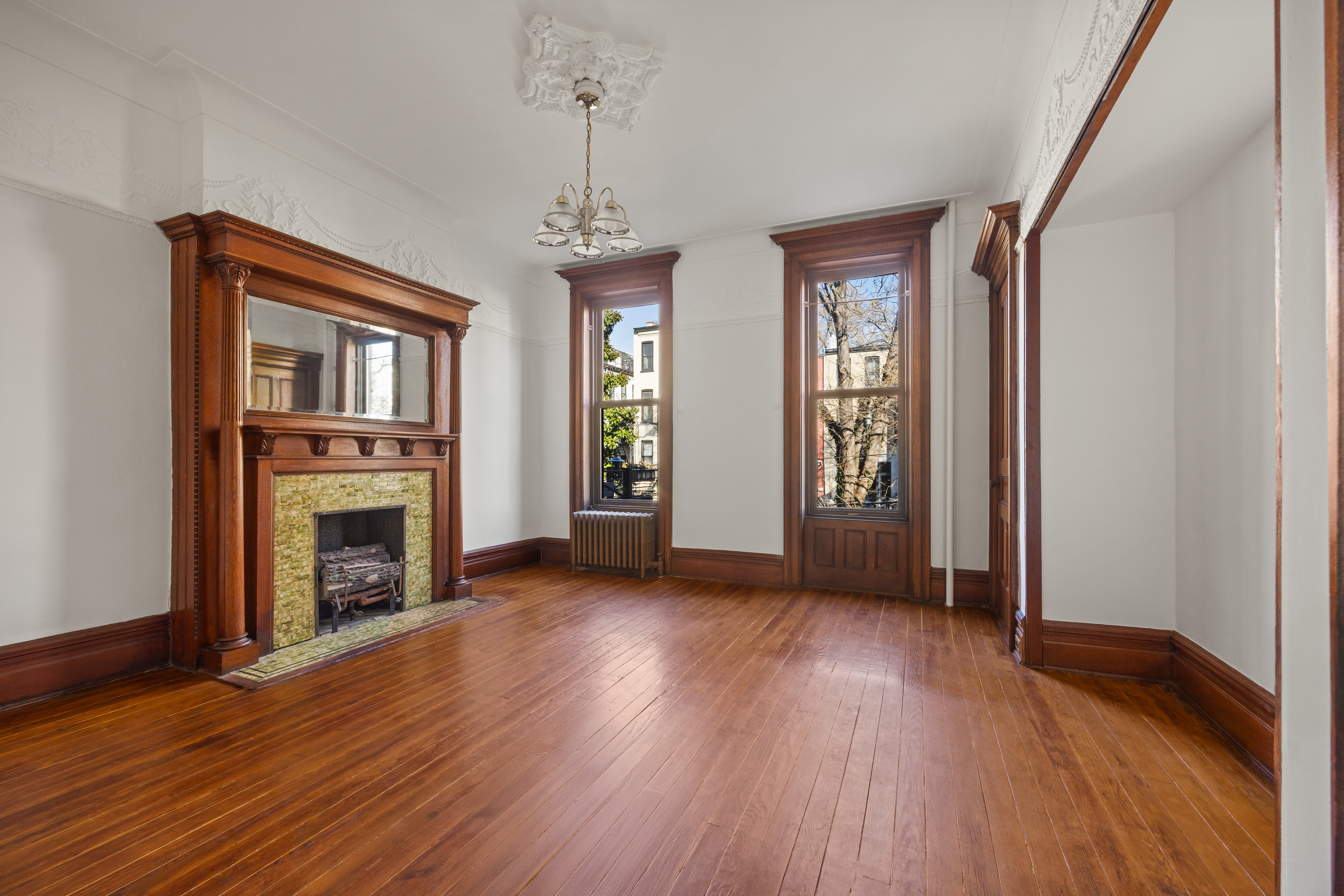 415 5th Street, Unit 1 Brooklyn, NY 11215 - Photo 3 of 14 a view of a livingroom with wooden floor a fireplace and windows