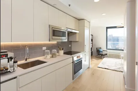 a kitchen with stainless steel appliances granite countertop a sink and a stove