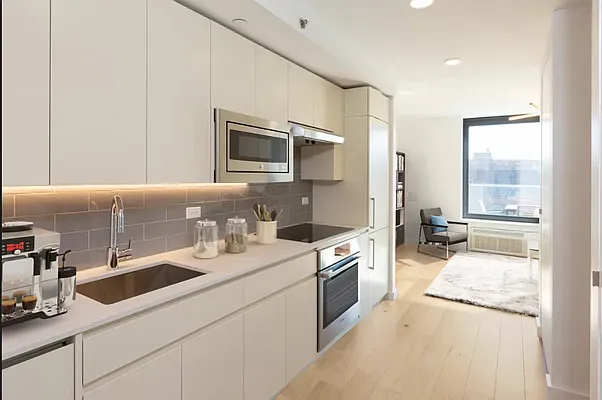 a kitchen with stainless steel appliances granite countertop a sink and a stove