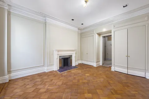a view of empty room with a fireplace and fan