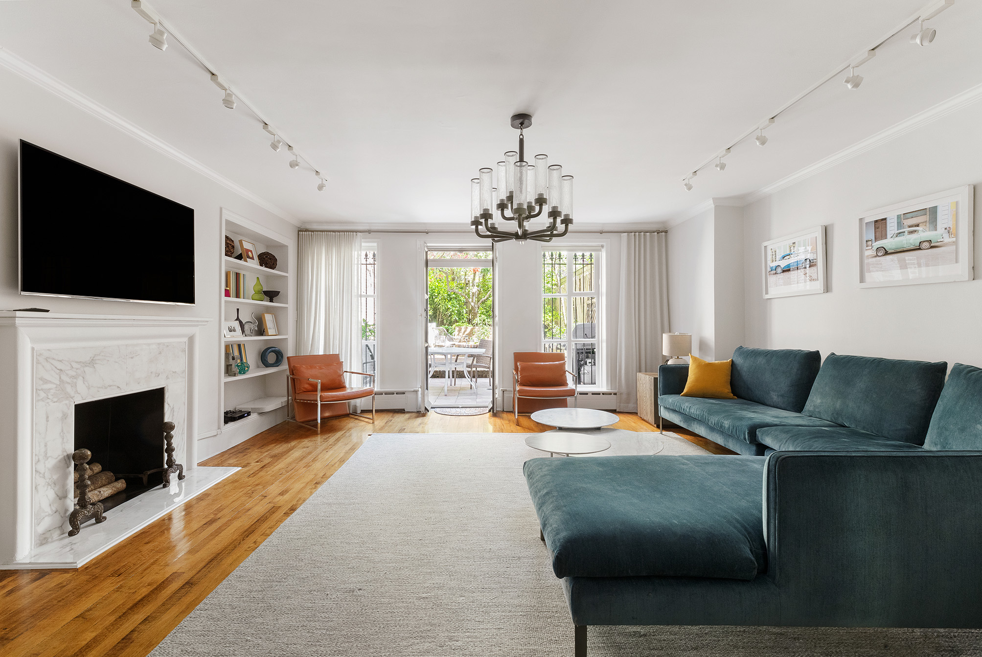209 East 61st Street Manhattan, NY 10065 - Photo 17 of 24 a living room with furniture fireplace and flat screen tv