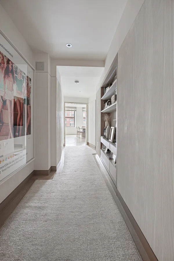 a living room with furniture and large windows