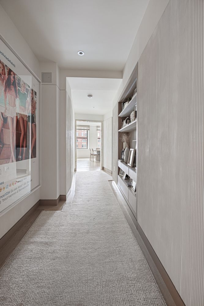 a living room with furniture and large windows