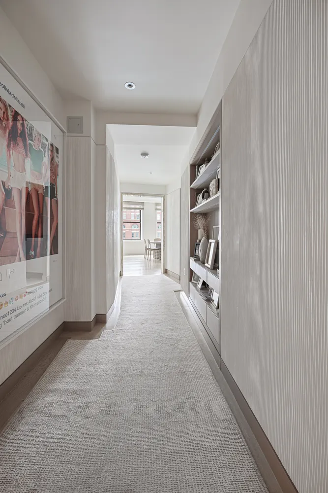 a living room with furniture and large windows